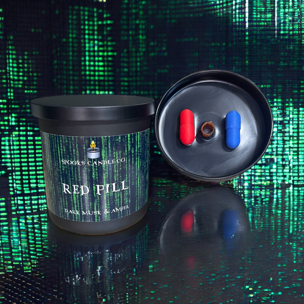 The Matrix inspired candle with a red and blue pill in a black glass candle container